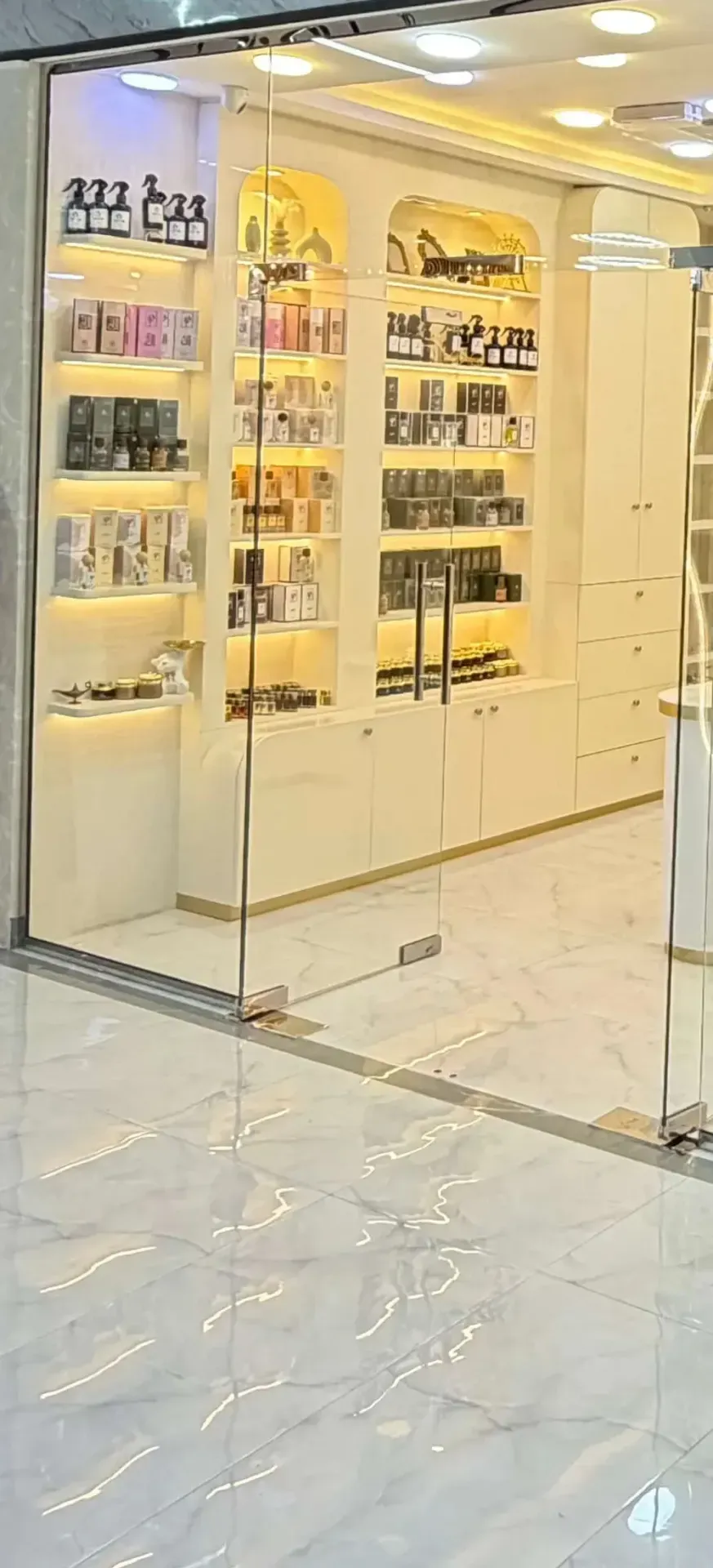Perfume bottles displayed on shelves at a Salem Mall fragrance boutique