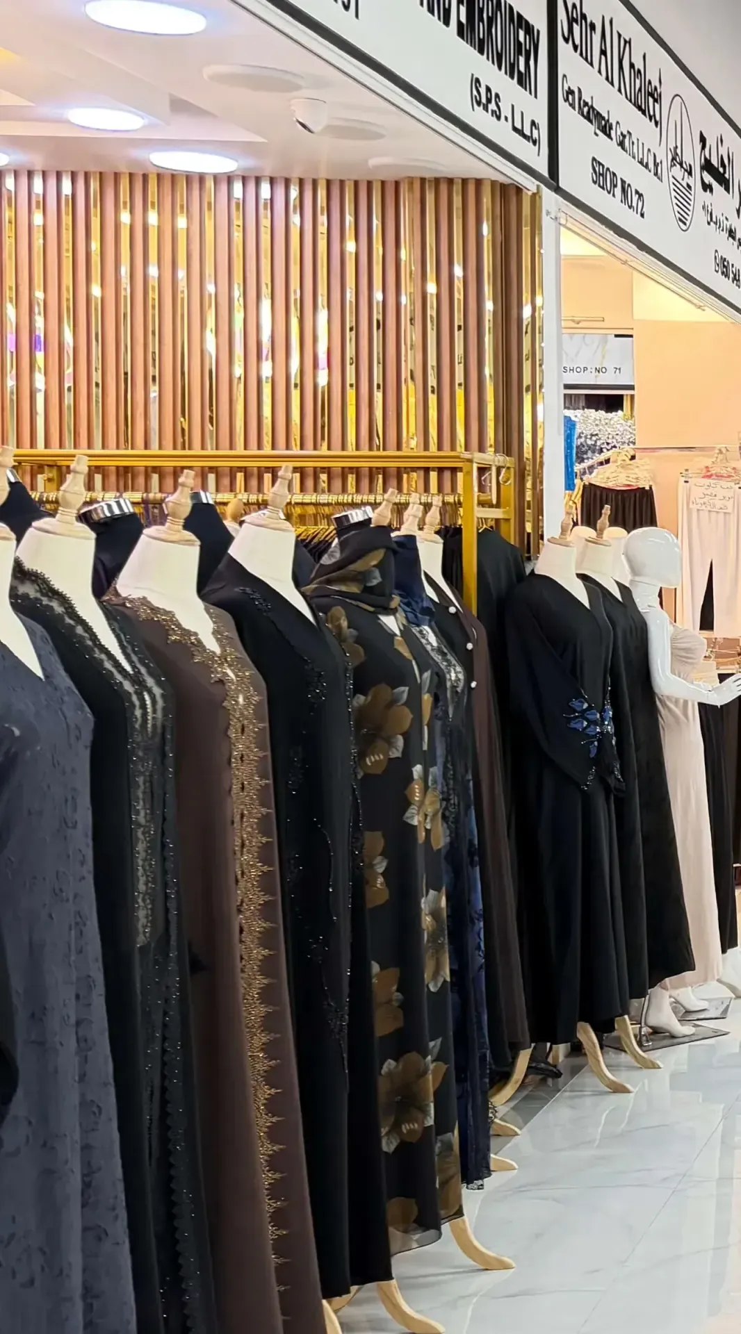 Row of embellished abaya mannequins at a Salem Mall boutique